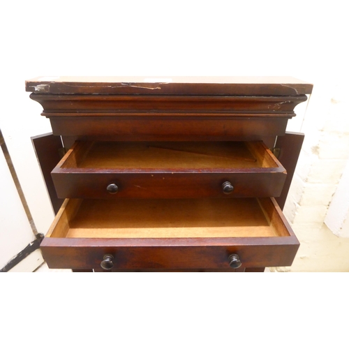 180 - An early Victorian diminutive mahogany  Wellington chest with ten drawers, on a plinth  28