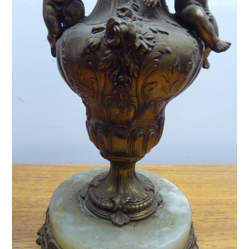 182 - Two mid 20thC gilt metal and onyx lamps, one shaped as a standing cherub  15