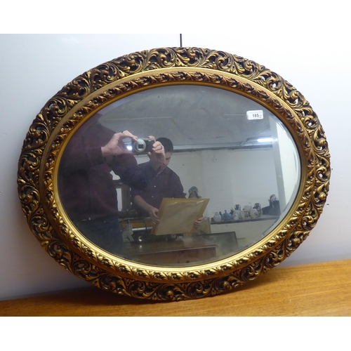 185 - Two similar mid 20thC mirrors, each in an ornate gilded plaster frame  largest 31