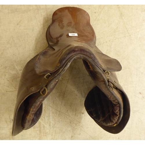 188 - Two brown hide horse saddles; and another in black hide