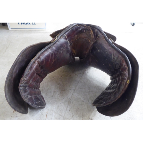 188 - Two brown hide horse saddles; and another in black hide