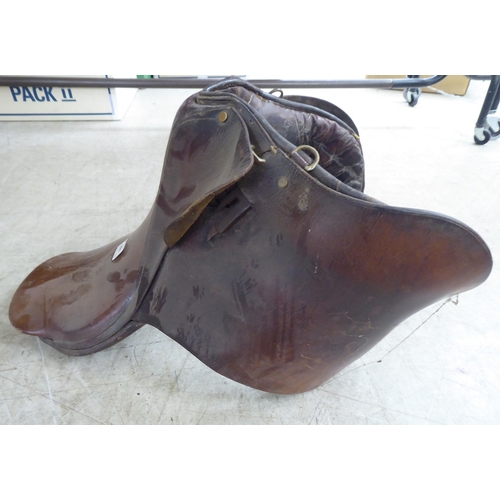 188 - Two brown hide horse saddles; and another in black hide