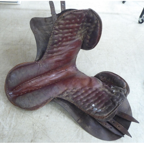 188 - Two brown hide horse saddles; and another in black hide