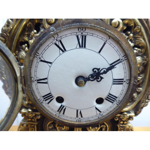 189 - A mid 20thC mantel clock, the brass case profusely decorated in Empire style; the 8 day movement fac... 