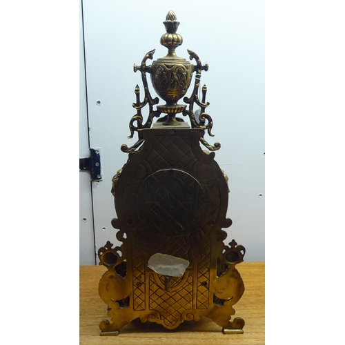 189 - A mid 20thC mantel clock, the brass case profusely decorated in Empire style; the 8 day movement fac... 