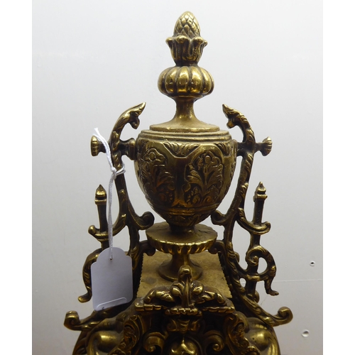 189 - A mid 20thC mantel clock, the brass case profusely decorated in Empire style; the 8 day movement fac... 