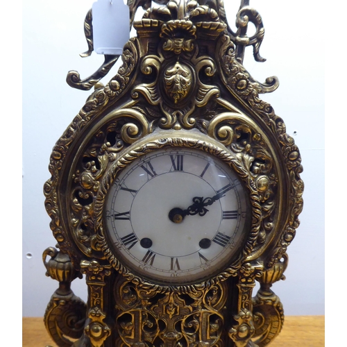 189 - A mid 20thC mantel clock, the brass case profusely decorated in Empire style; the 8 day movement fac... 