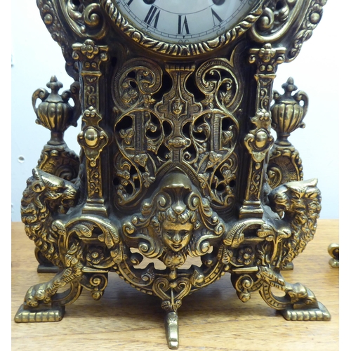 189 - A mid 20thC mantel clock, the brass case profusely decorated in Empire style; the 8 day movement fac... 