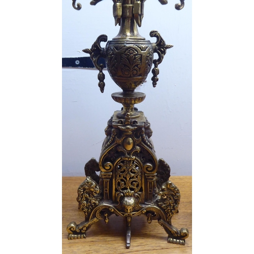 189 - A mid 20thC mantel clock, the brass case profusely decorated in Empire style; the 8 day movement fac... 