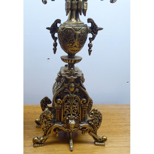 189 - A mid 20thC mantel clock, the brass case profusely decorated in Empire style; the 8 day movement fac... 