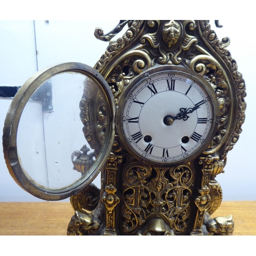 189 - A mid 20thC mantel clock, the brass case profusely decorated in Empire style; the 8 day movement fac... 