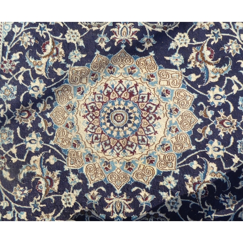 190 - An Iranian Nain woollen rug with stylised motifs, on a beige ground  120