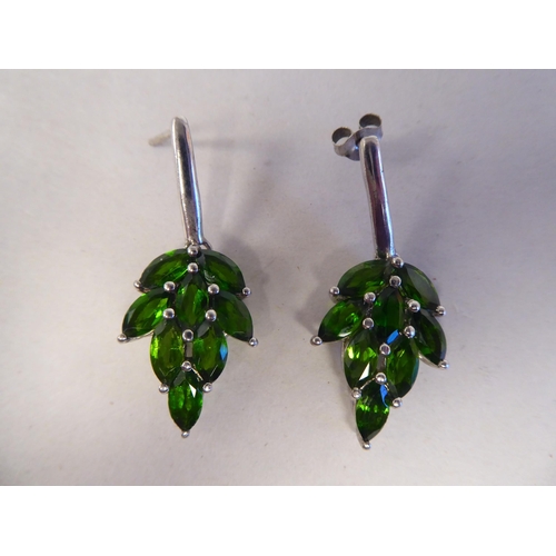 191 - A pair of white metal earrings, fashioned as leaves, set with green stones  stamped 925