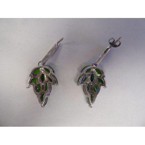 191 - A pair of white metal earrings, fashioned as leaves, set with green stones  stamped 925