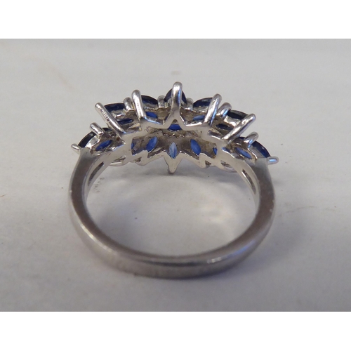 192 - A white metal cluster ring, set with oval cut sapphires  stamped 925