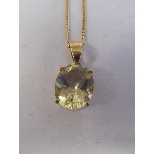 194 - A 9ct gold pendant, set with a lemon quartz, on a 9ct gold chain 