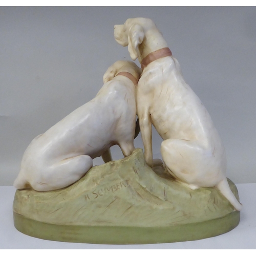 20 - A Royal Dux porcelain model, a pair of seated hounds, on an oval, naturalistically moulded plinth, i... 