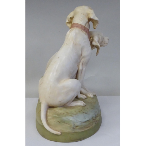 20 - A Royal Dux porcelain model, a pair of seated hounds, on an oval, naturalistically moulded plinth, i... 