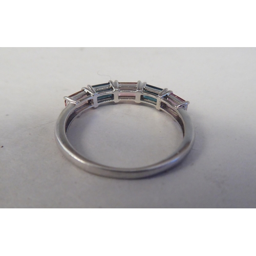 200 - A 9ct white gold ring, set with alternating pink and green tourmalines 