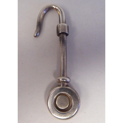 206 - A silver napkin holder with a hooked end; and another  mixed marks 