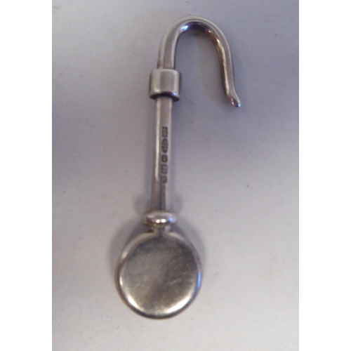 206 - A silver napkin holder with a hooked end; and another  mixed marks 