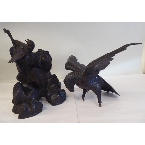 208 - A cast and patinated bronze model eagle, on a rock with captured prey  16