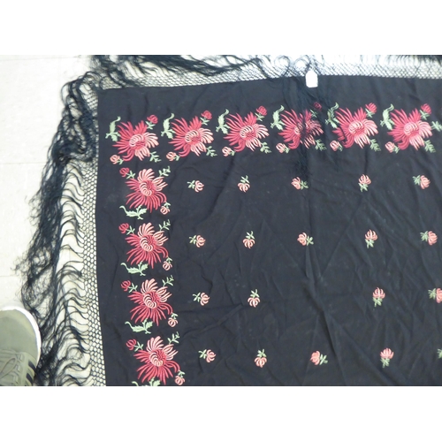 220 - An embroidered Black fabric piano shawl, decorated with flora  48