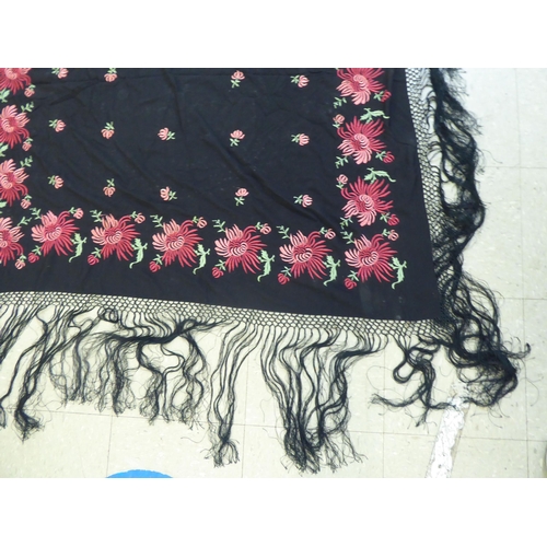 220 - An embroidered Black fabric piano shawl, decorated with flora  48