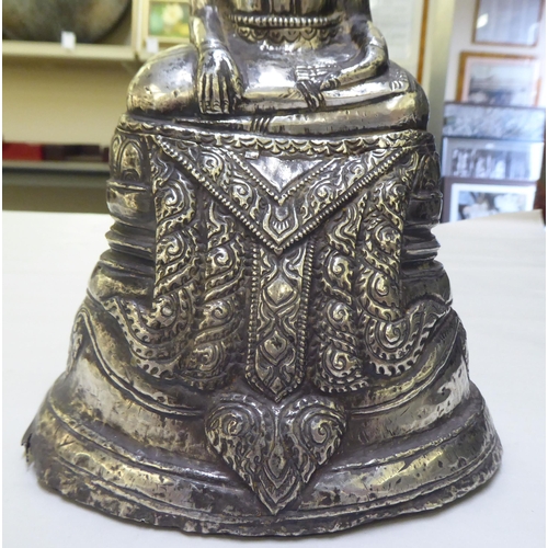 225 - A white coloured metal covered seated Buddha  10.5