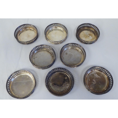 3 - A set of eight silver coloured metal coasters with decoratively pierced galleried sides  stampe... 