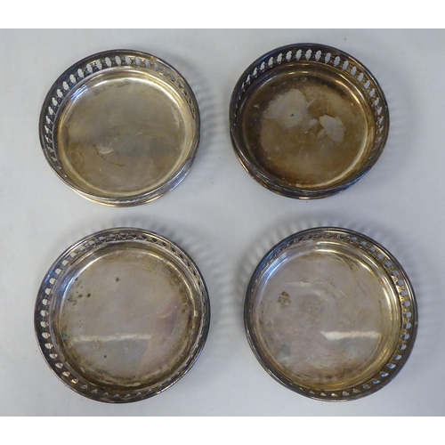 3 - A set of eight silver coloured metal coasters with decoratively pierced galleried sides  stampe... 