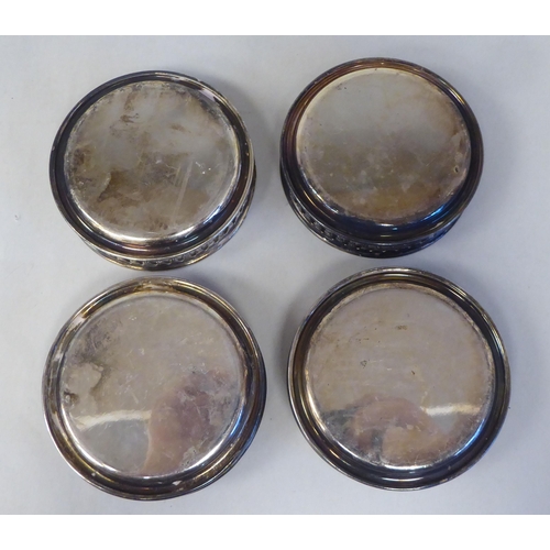 3 - A set of eight silver coloured metal coasters with decoratively pierced galleried sides  stampe... 