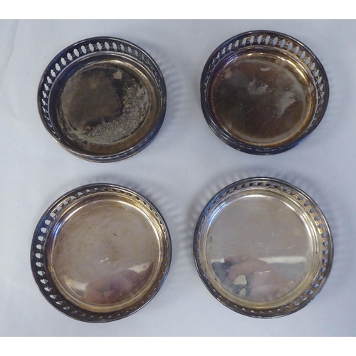 3 - A set of eight silver coloured metal coasters with decoratively pierced galleried sides  stampe... 