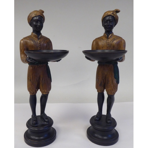 31 - A pair of painted cold cast bronze blackamoor figures, featuring two boys, wearing turbans, each car... 