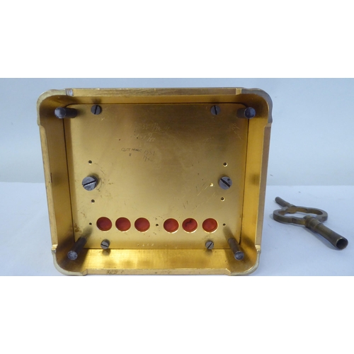 34 - An early 20thC French lacquered brass cased carriage clock with a folding top handle and bevelled gl... 