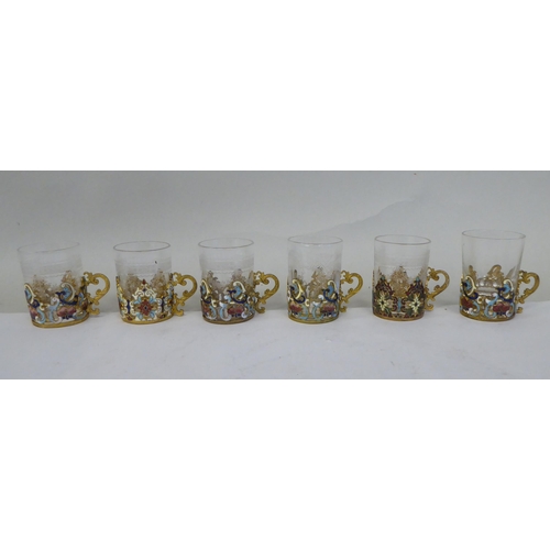 37 - A set of six Venetian decoratively engraved, cylindrical tot glasses, set in coloured enamel and gil... 