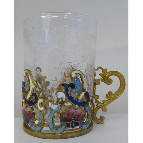 37 - A set of six Venetian decoratively engraved, cylindrical tot glasses, set in coloured enamel and gil... 