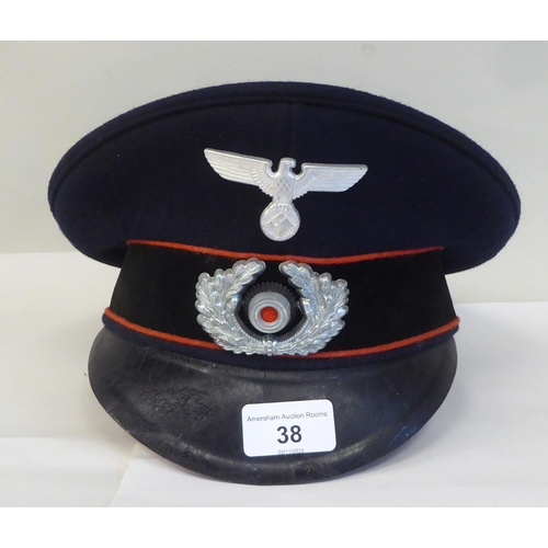 38 - A German military peaked cap with badge(Please Note: this lot is subject to the statement made in th... 