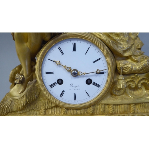 42 - A 19thC French gilt metal cased mantel clock, featuring a seated couple, on a draped cushion, the de... 