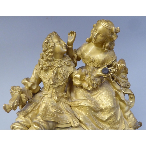 42 - A 19thC French gilt metal cased mantel clock, featuring a seated couple, on a draped cushion, the de... 