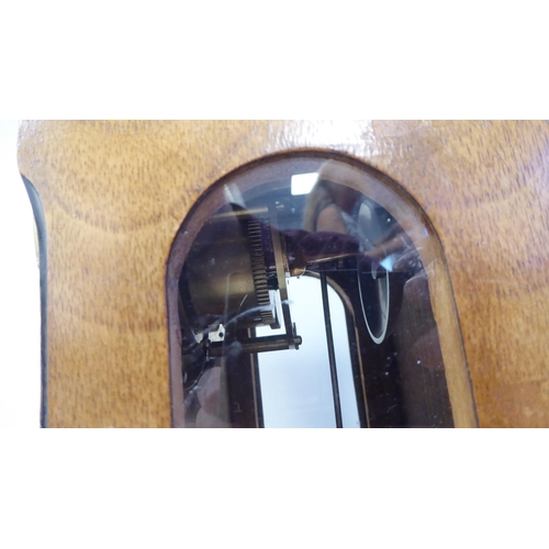 45 - An early 20thC part lacquered walnut cased mantel clock with a round arch top and flank windows, on ... 