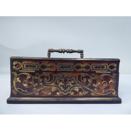 51 - A late 19thC desktop boulleworked tortoiseshell stand with straight sides and two outward hinged fla... 