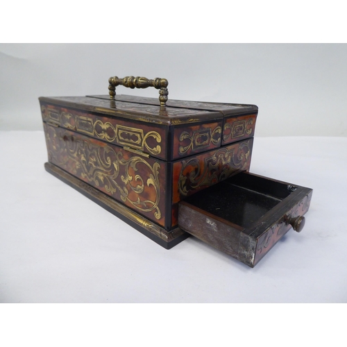 51 - A late 19thC desktop boulleworked tortoiseshell stand with straight sides and two outward hinged fla... 