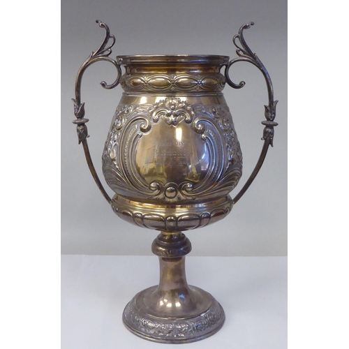 53 - A late 19thC silver Bulawayo Rifle Club trophy cup of pedestal form with twin handles, cast and chas... 