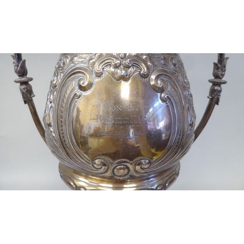 53 - A late 19thC silver Bulawayo Rifle Club trophy cup of pedestal form with twin handles, cast and chas... 