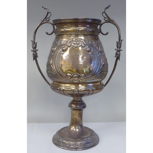 53 - A late 19thC silver Bulawayo Rifle Club trophy cup of pedestal form with twin handles, cast and chas... 