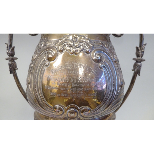 53 - A late 19thC silver Bulawayo Rifle Club trophy cup of pedestal form with twin handles, cast and chas... 