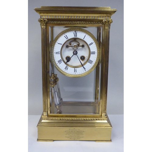 57 - A late Victorian lacquered brass, four glass mantel clock with bevelled panels; the visible bell str... 