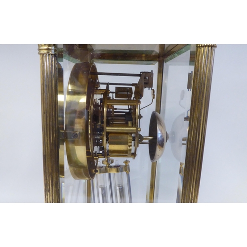 57 - A late Victorian lacquered brass, four glass mantel clock with bevelled panels; the visible bell str... 