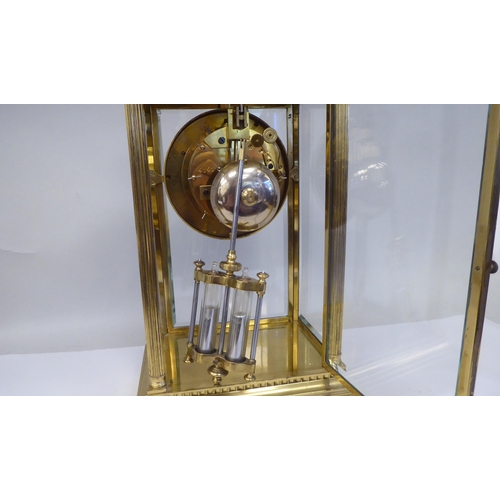 57 - A late Victorian lacquered brass, four glass mantel clock with bevelled panels; the visible bell str... 